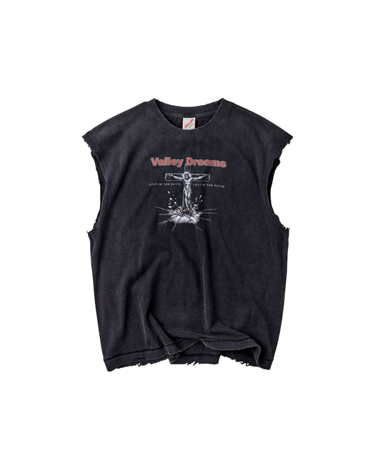 A black acid-washed sleeveless crop top with distressed frayed edges, featuring a white graphic of a crucifix and the text 'Valley Dreams' in red and white on the chest.