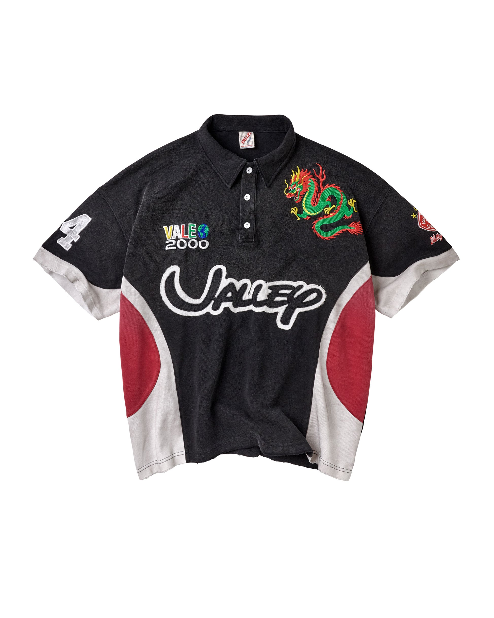 A black short-sleeve polo shirt with red and white side panels, featuring a green dragon graphic on the right chest, a white stylized 'Valley' logo across the front, and a 'Vale 2000' graphic on the left chest.