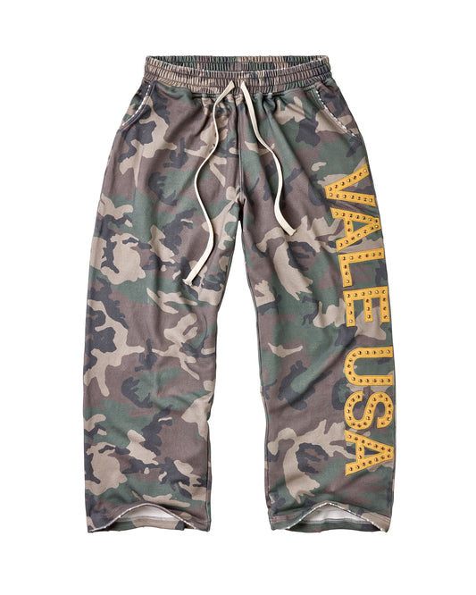 A pair of camouflage sweatpants featuring a green, brown, and gray camo pattern, an elastic waistband with white drawstrings, and a large yellow 'VALE USA' graphic printed vertically on the right leg.