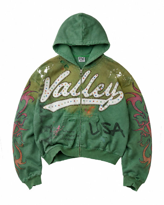 A green zip-up hoodie with a distressed, washed finish, featuring a large 'Valley' graphic across the chest with rhinestones, 'USA' text on the front, and red and orange flame patterns on the sleeves.