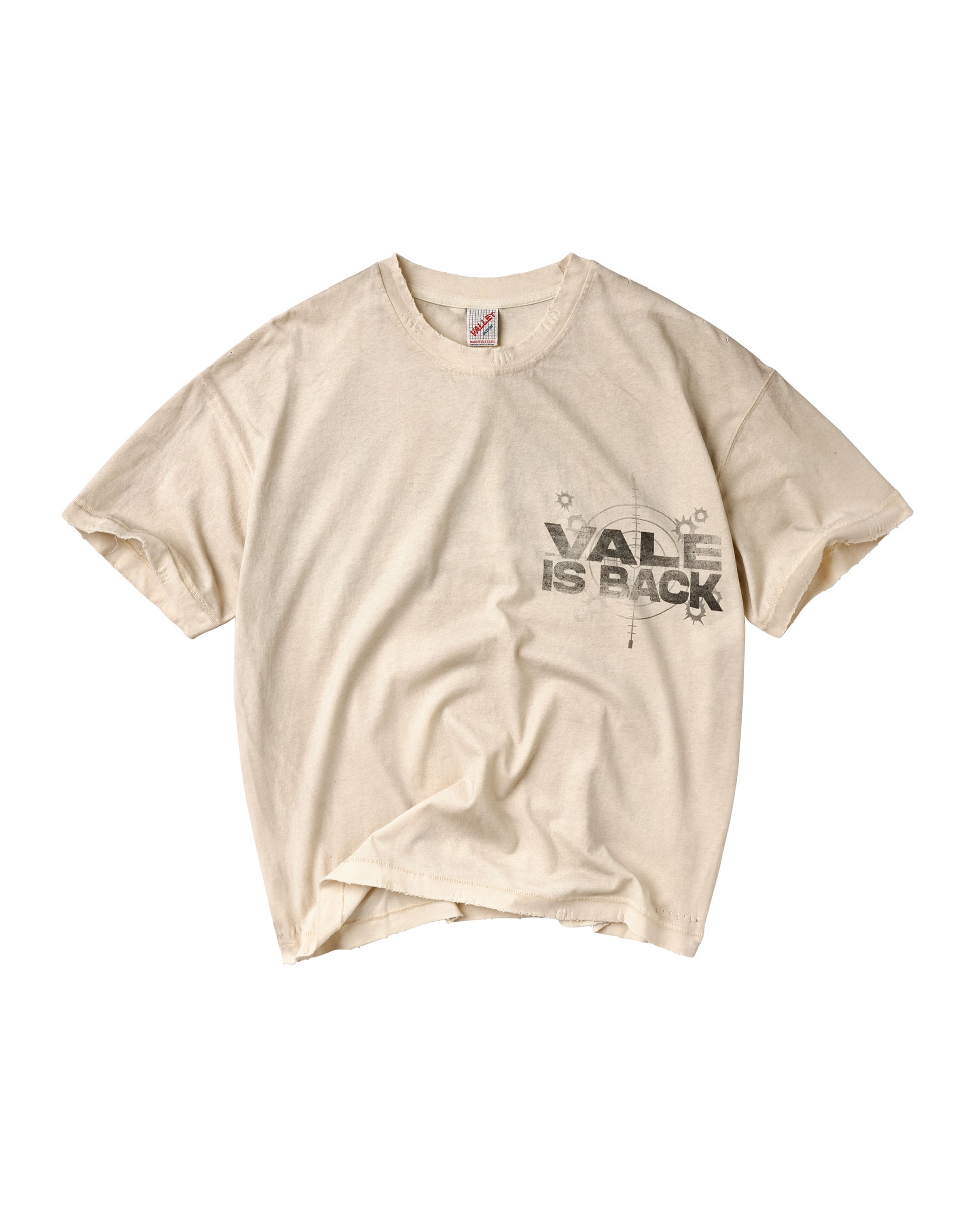 A cream-colored short-sleeve t-shirt with a distressed black graphic on the left chest that reads 'VALE IS BACK' with a compass design.