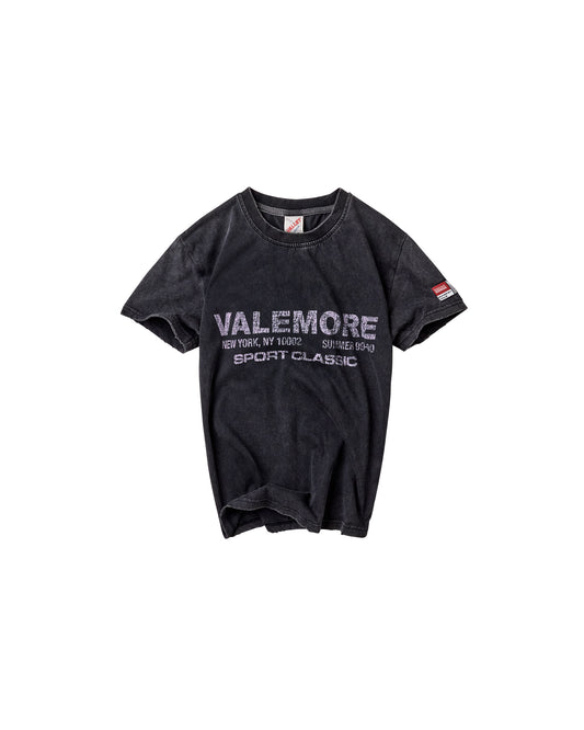A faded black short-sleeve t-shirt with 'VALEMORE SPORT CLASSIC' printed in white across the chest, displayed flat against a solid white background.