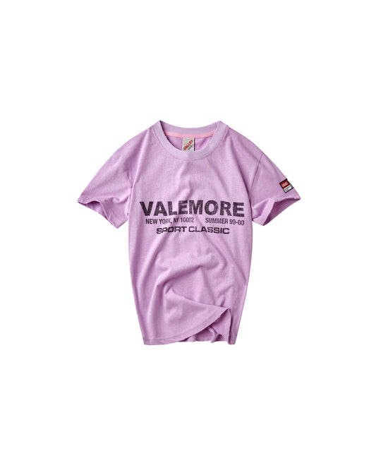 A light purple short-sleeve t-shirt with 'VALEMORE' printed in black across the chest, displayed flat against a solid white background.
