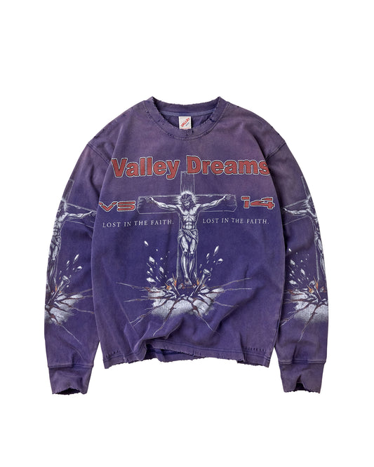 A purple mineral-wash crewneck sweatshirt featuring a graphic of Jesus on the cross with the text 'Valley Dreams' in red across the chest, displayed flat against a white background.
